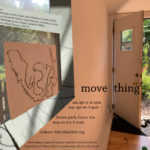 poster of move thing with contextual information pasting over a room with the door opening to a garden.